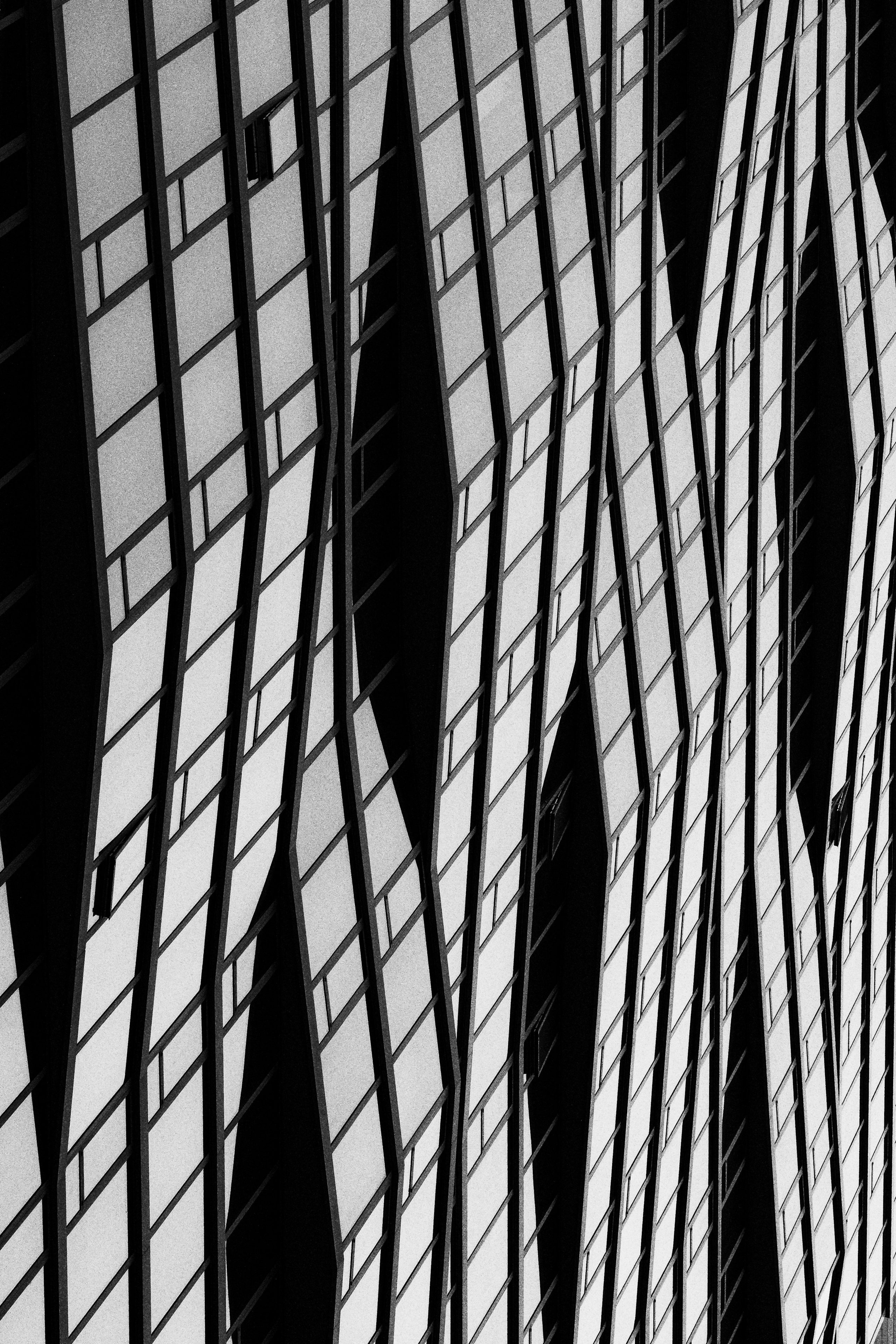 Rows of windows form a stark black-and-white architectural pattern.