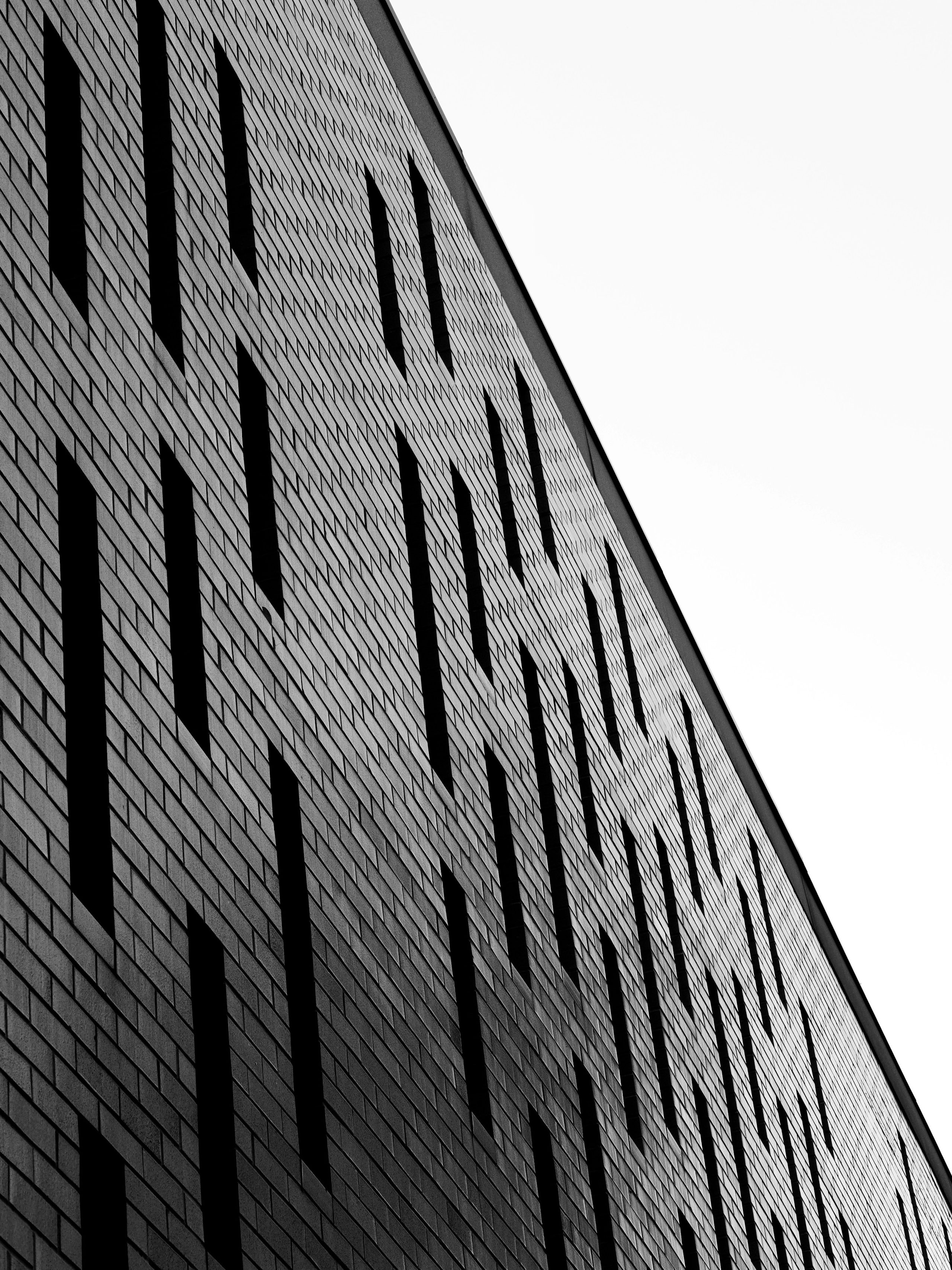 Brick panels and recessed windows create a repeating vertical pattern.